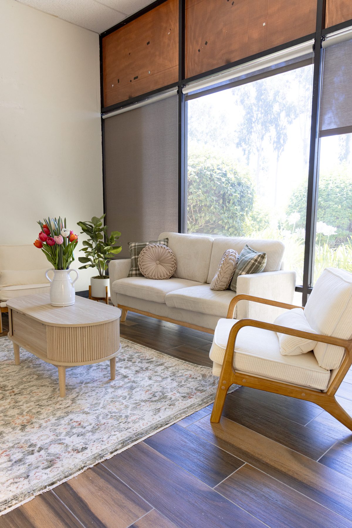 The IMS lounge with natural light, seating, and a garden view